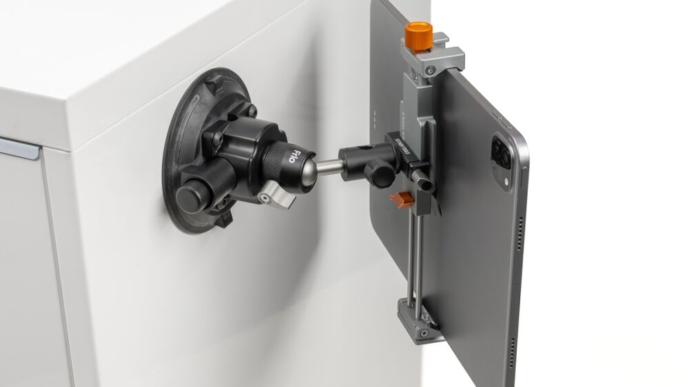 Smartphone mounted in a clamp to a precision optical instrument for imaging.