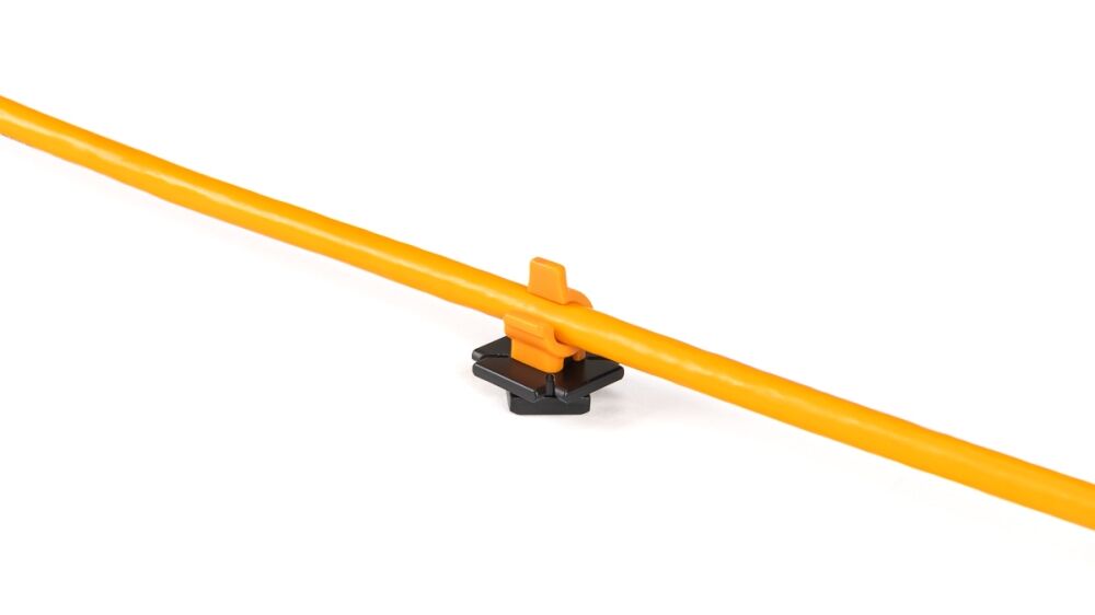 Close-up of an orange plastic rod held by a small black-and-orange clip on a white background.