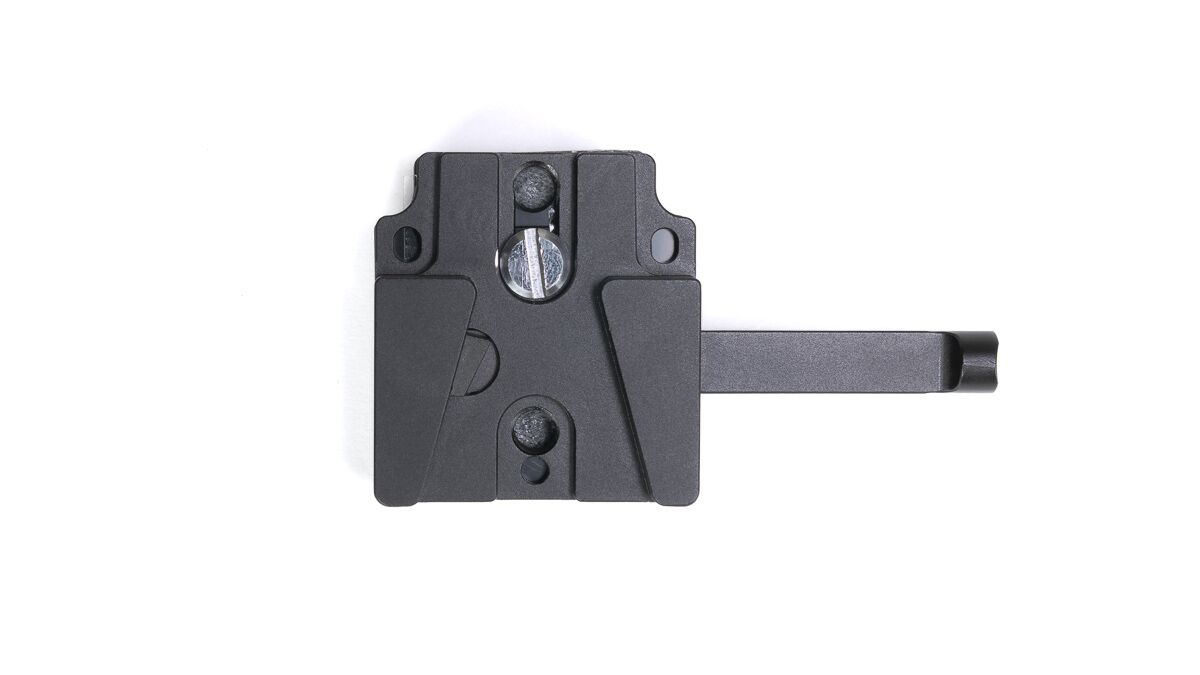Black tripod quick-release plate with a sliding dovetail and mounting screw, extending a long rail to the right