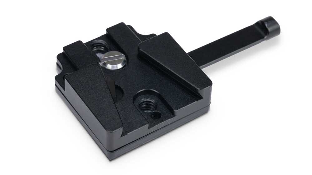 Black metal quick-release clamp with adjustable jaws and a long lever, used to secure parts in a jig or fixture in a workshop.