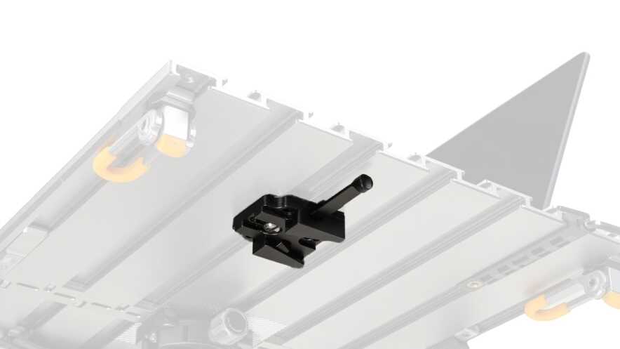 Black lever clamp mounted on a rail system atop a gray platform, likely part of a printer or CNC frame