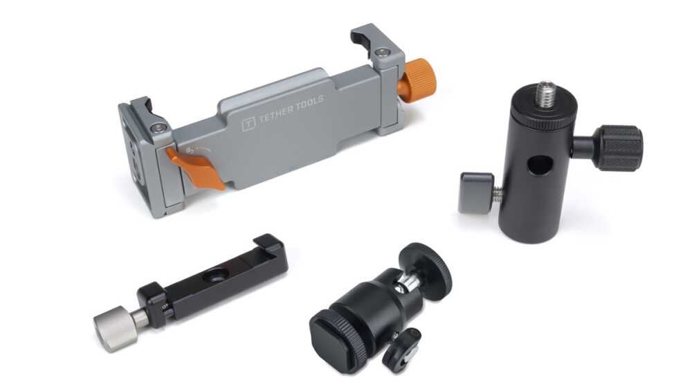 Set of camera mounting clamps and supports arranged on a white surface (Tether Tools components)