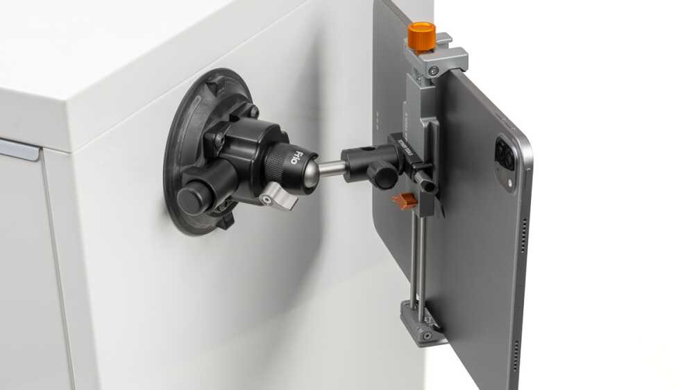 Smartphone mounted in a clamp to a precision optical instrument for imaging.