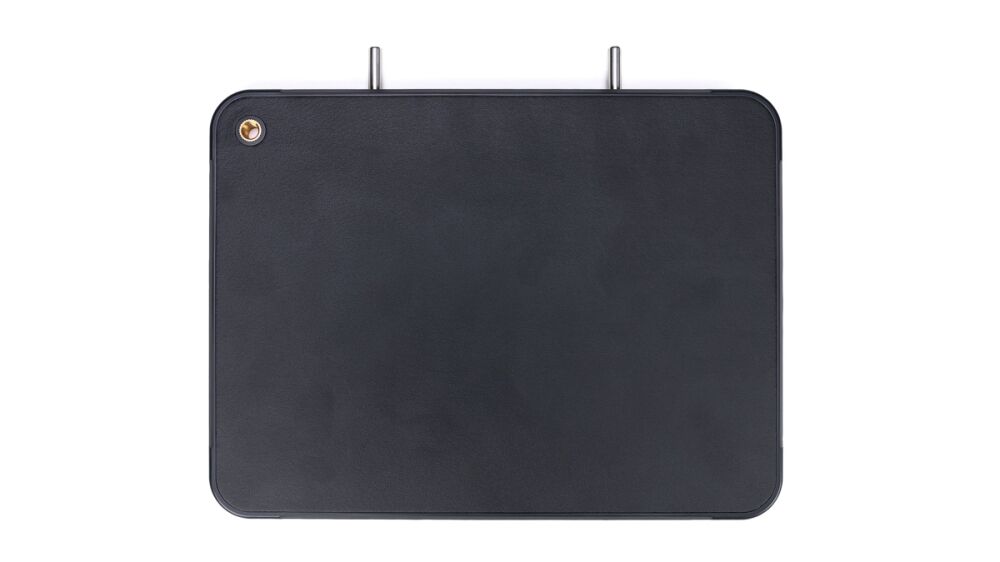 Rectangular dark leather panel with rounded corners, two metal prongs at the top, and a small brass screw in the top-left corner.