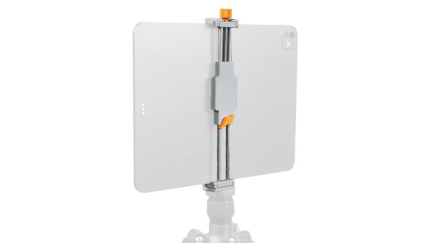 Tablet attached to a vertical clamp mount on a tripod with orange adjustment knobs, used for stable filming or photography setups.